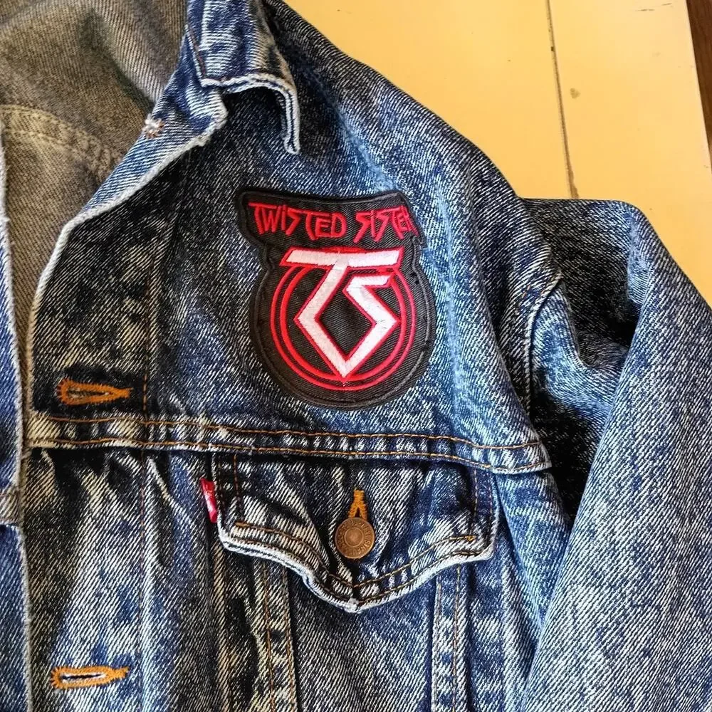 Vintage 1980'S Levi's jean jacket with rock band patches on it. Size large.